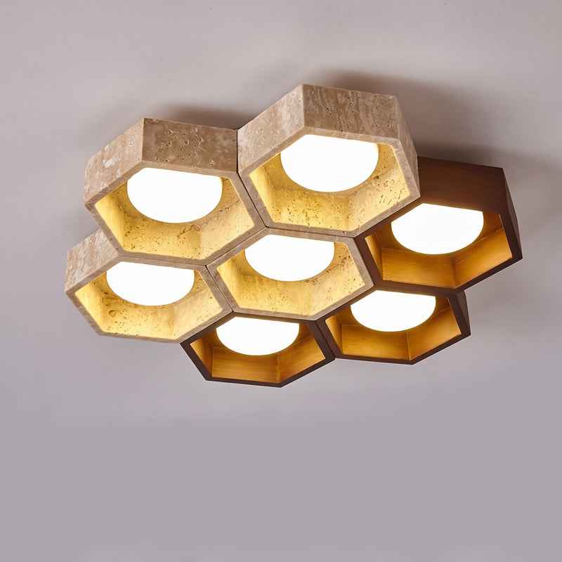 Alveola Honeycomb Travertine Ceiling Light, seven-light cluster of travertine and walnut-colour hexagons, lit, on a light ceiling