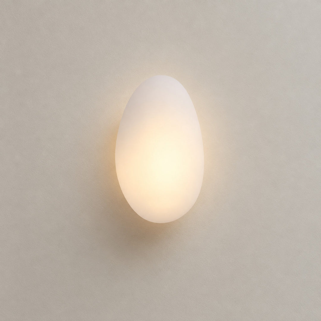 Bubble Glass Wall Lamp, white frosted glass Model A lit on a plaster wall