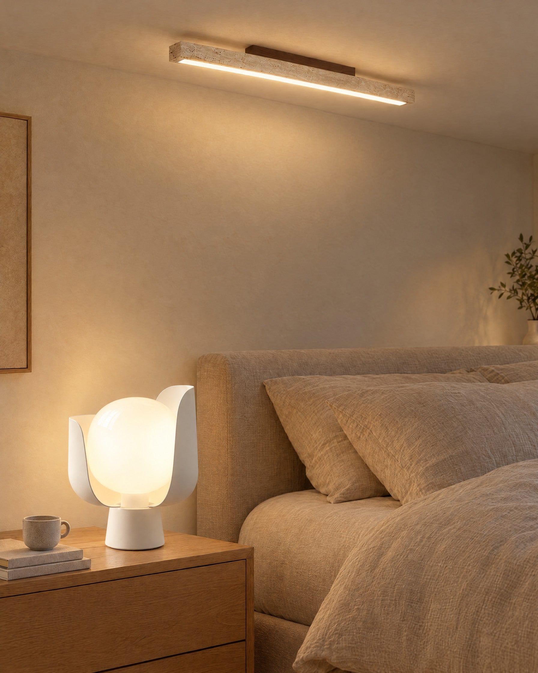 Pethella Table Lamp in white, lit on an oak nightstand, with the Travellin Ceiling Light on the bedroom ceiling above
