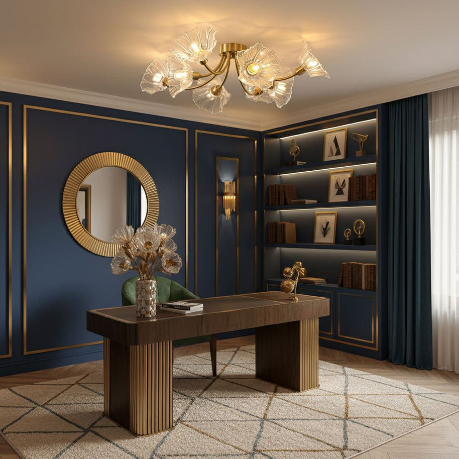 Flush-mount ceiling lamp with curved brass arms holding clear ribbed flower-shaped glass shades lit above a desk in a room with dark blue panelling.