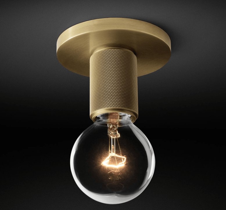 Close view of the brass ceiling plate and knurled holder with the bulb lit.