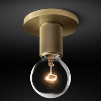 Close view of the brass ceiling plate and knurled holder with the bulb lit.