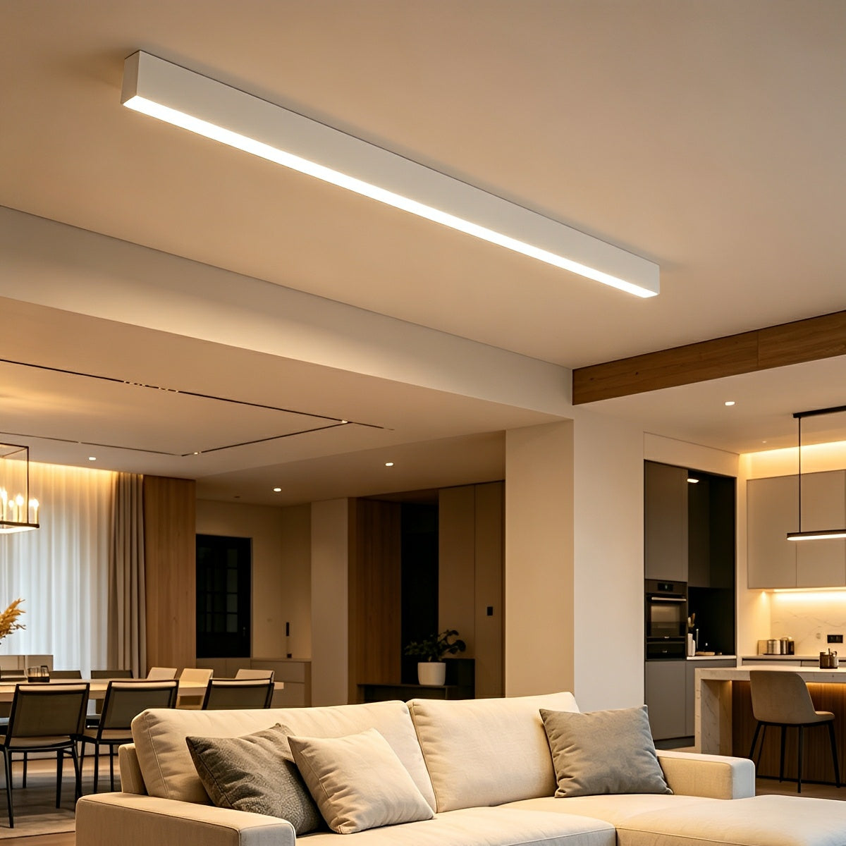 Slim linear LED ceiling light with a white body, fitted along a ceiling above an open-plan room.