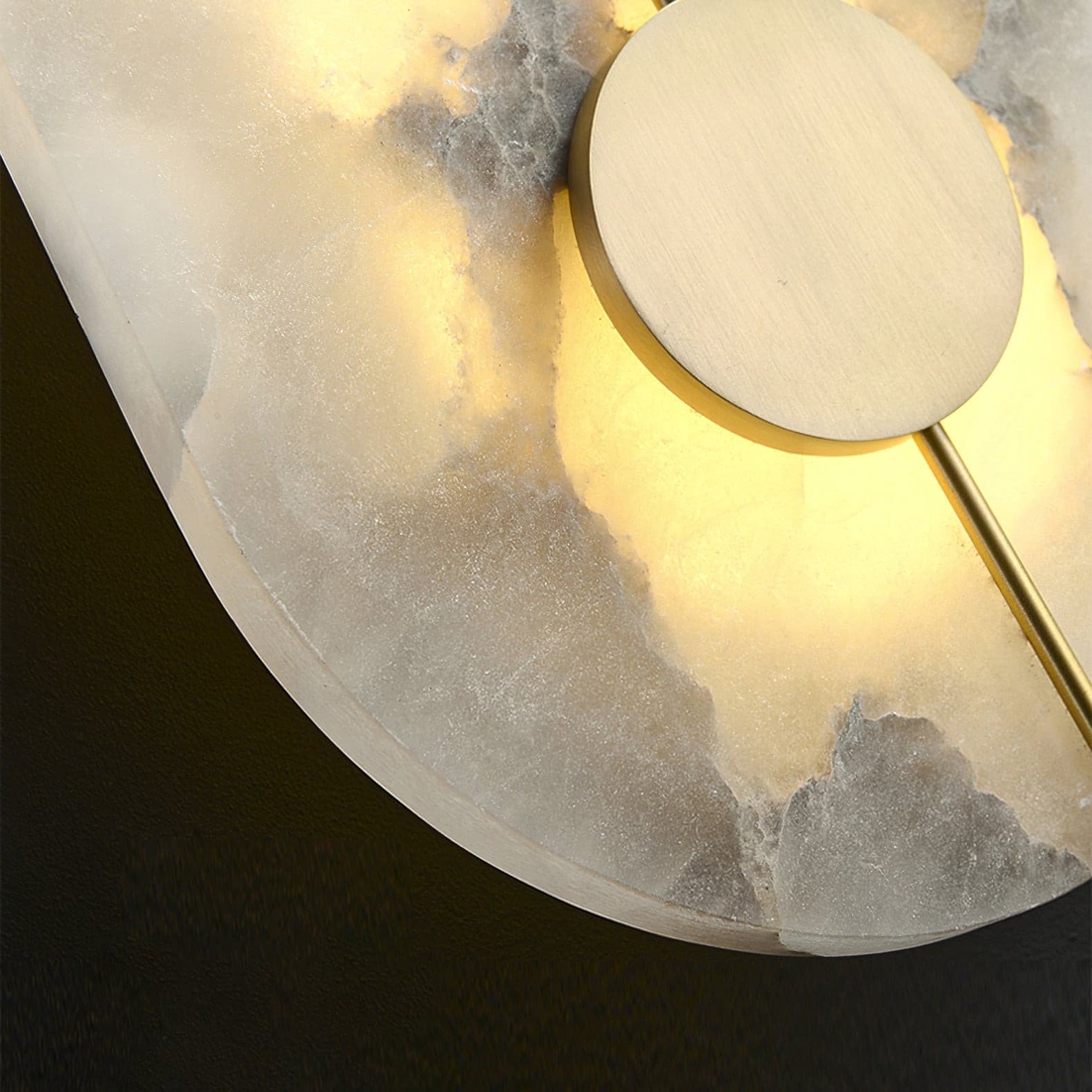 Close view of the brass centre disc against the lit alabaster.
