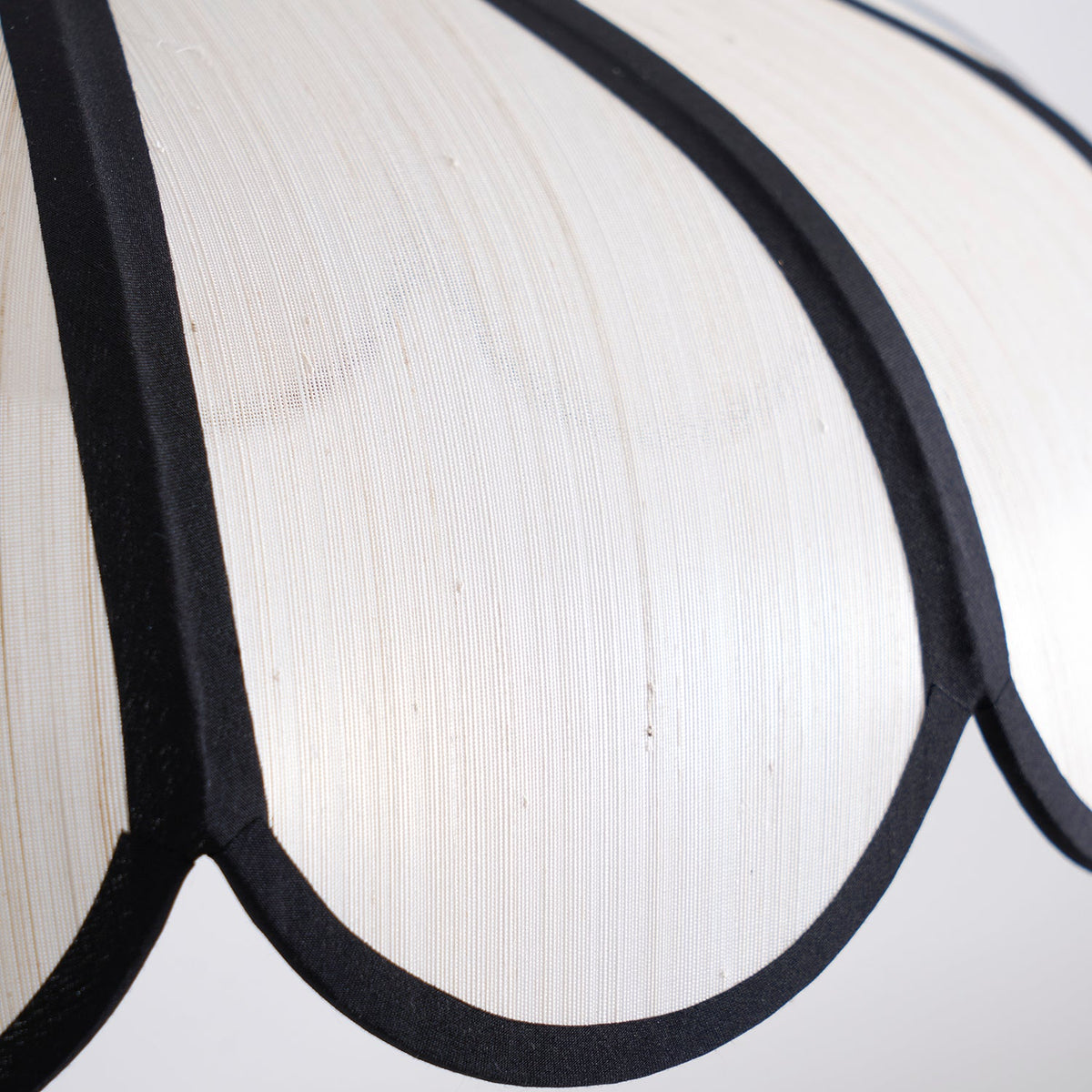 Close view of the shade surface showing its woven texture and a dark rib.