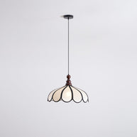 Pendant light with a scalloped beige shade, dark ribs and a turned walnut-coloured wooden top shown whole and lit on a white background.