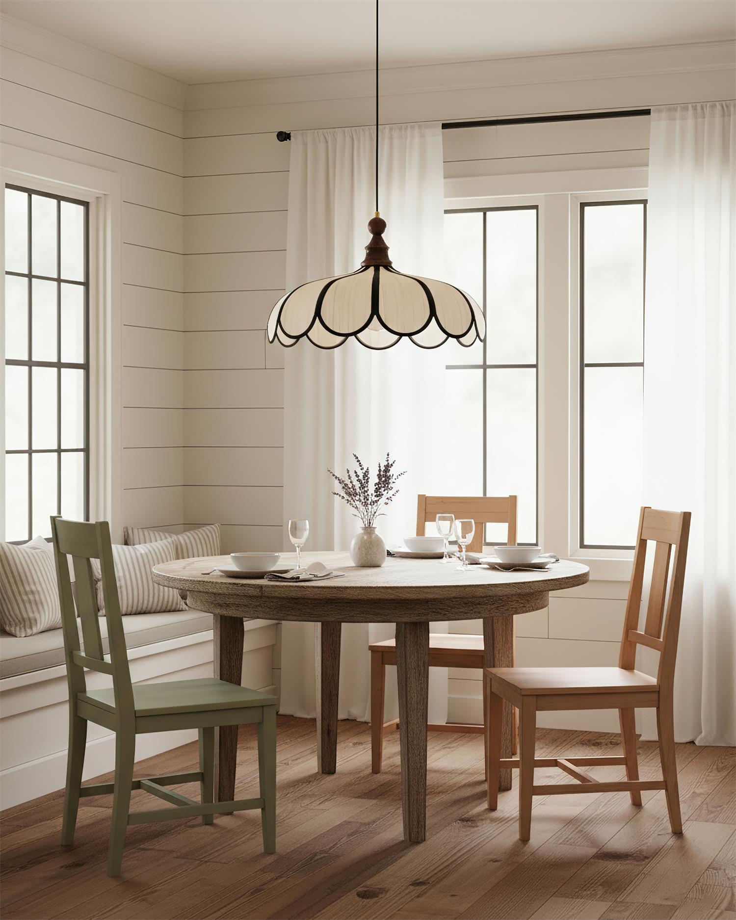 Pendant light with a scalloped beige shade, dark ribs and a turned walnut-coloured wooden top hanging above a round dining table in a panelled room.
