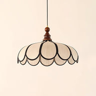 Pendant light with a scalloped beige shade, dark ribs and a turned walnut-coloured wooden top, shown on a plain background.