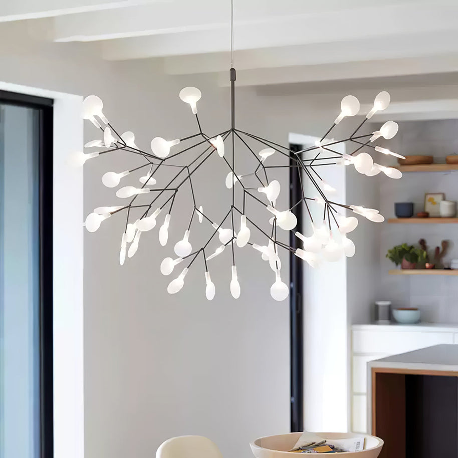 Comvilo firefly LED chandelier in black, lit above an open-plan kitchen and dining area