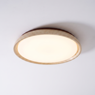 Pietra Walnut Travertine Ceiling Light in walnut colour and beige, shown lit with warm white light.