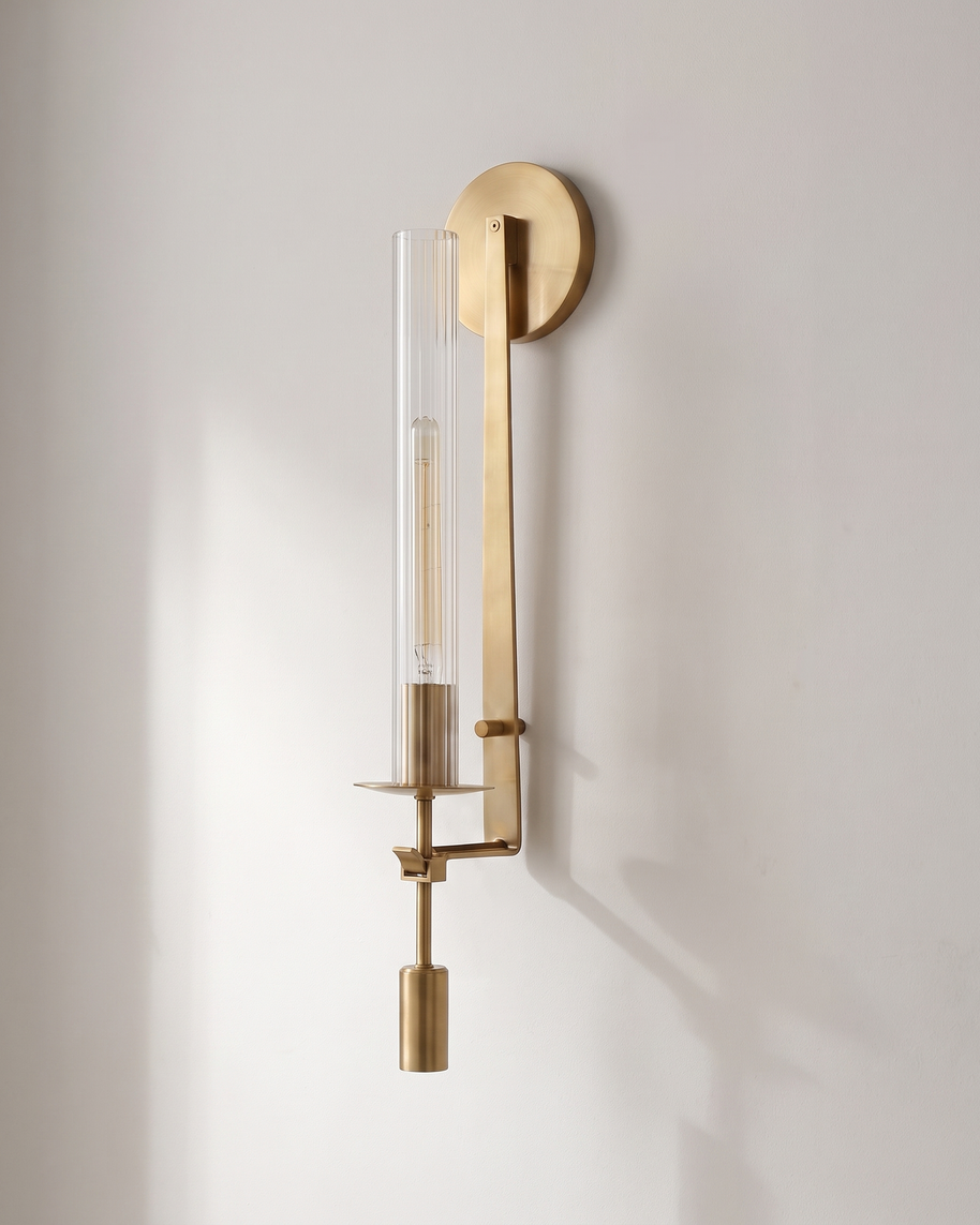 Valenne Ribbed Glass Wall Sconce mounted on a pale plaster wall in daylight