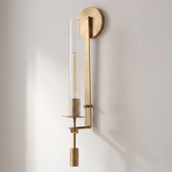 Valenne Ribbed Glass Wall Sconce mounted on a pale plaster wall in daylight