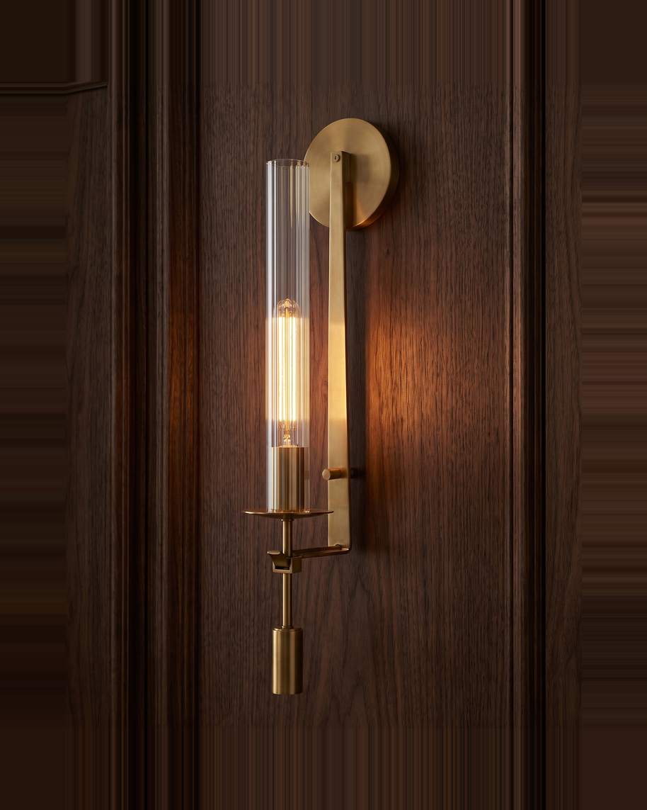 Valenne Ribbed Glass Wall Sconce lit against dark walnut panelling