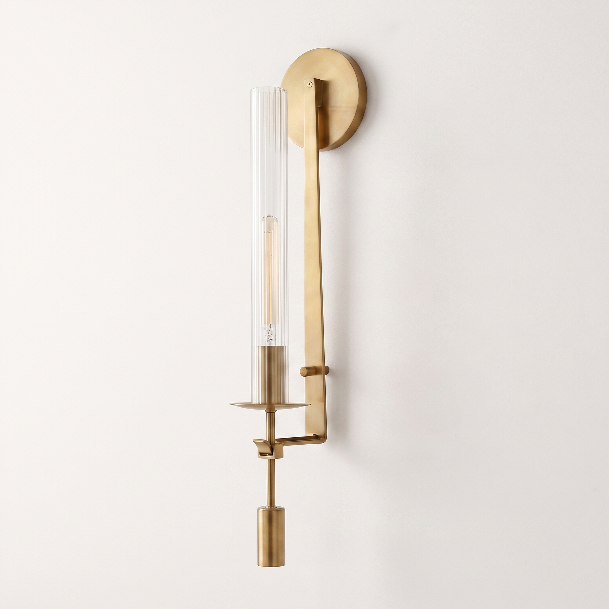 Valenne Ribbed Glass Wall Sconce, three-quarter studio view of the brass arm and ribbed glass cylinder
