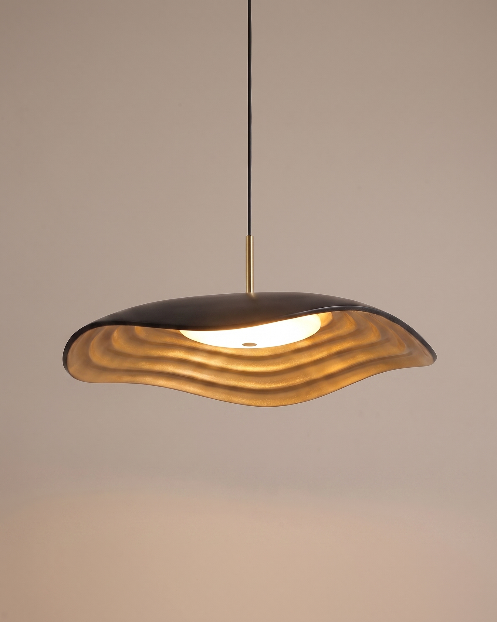 Comvilo Valentina Pendant Lamp in black resin and acrylic, shown lit with warm light.