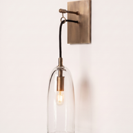Comvilo Lure Wall Lamp in brass and clear, installed, from a different vantage.