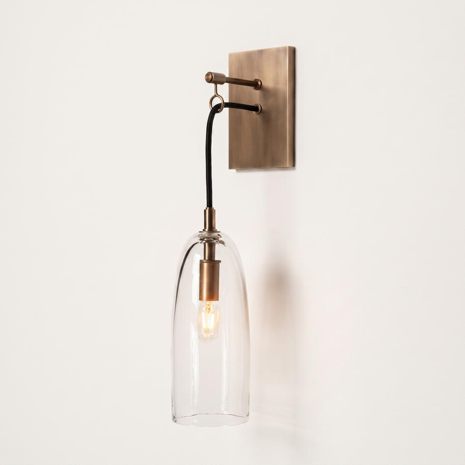 Comvilo Lure Wall Lamp in brass and clear, at a three-quarter studio angle.