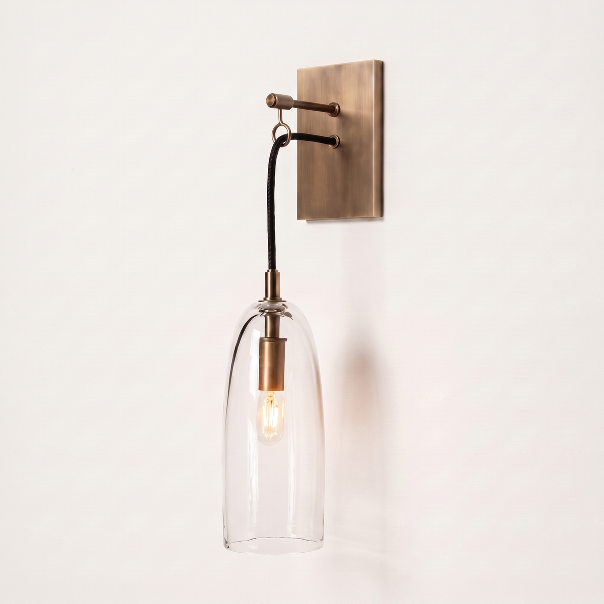 Comvilo Lure Wall Lamp in brass and clear, showing construction and wall mounting