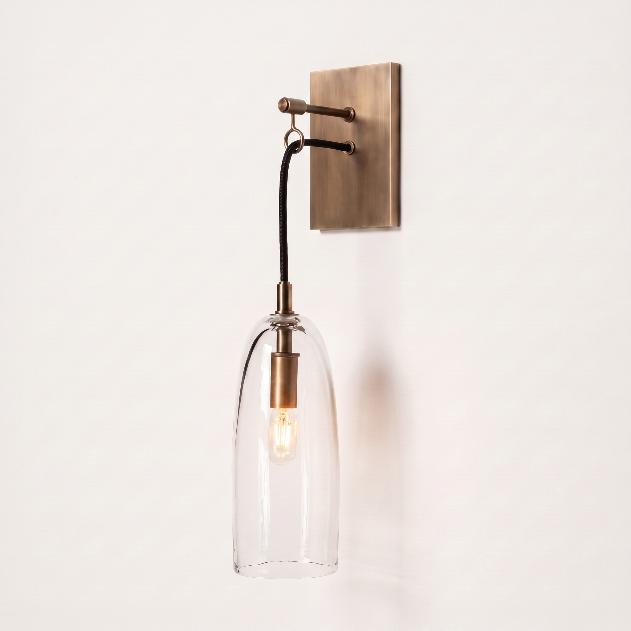 Comvilo Lure Wall Lamp in brass and clear, showing construction and wall mounting.
