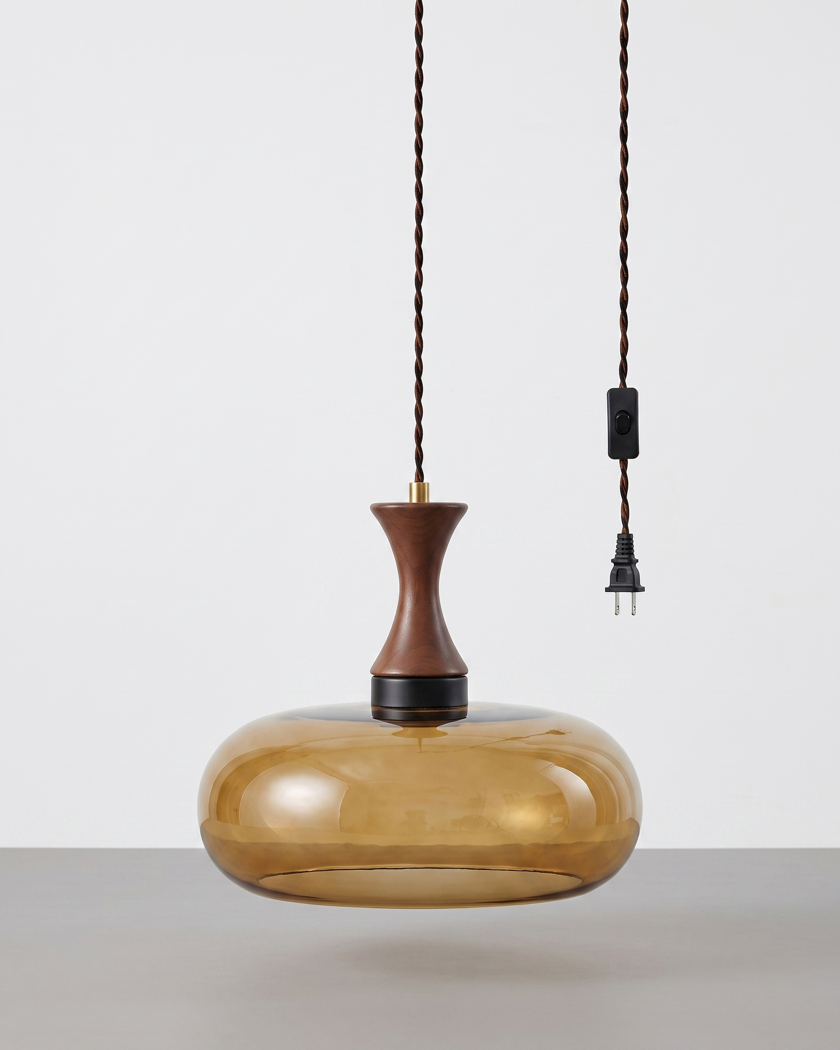 Orlena Antique Brown Glass Plug-In Pendant in antique brown glass, installed in a plain interior.
