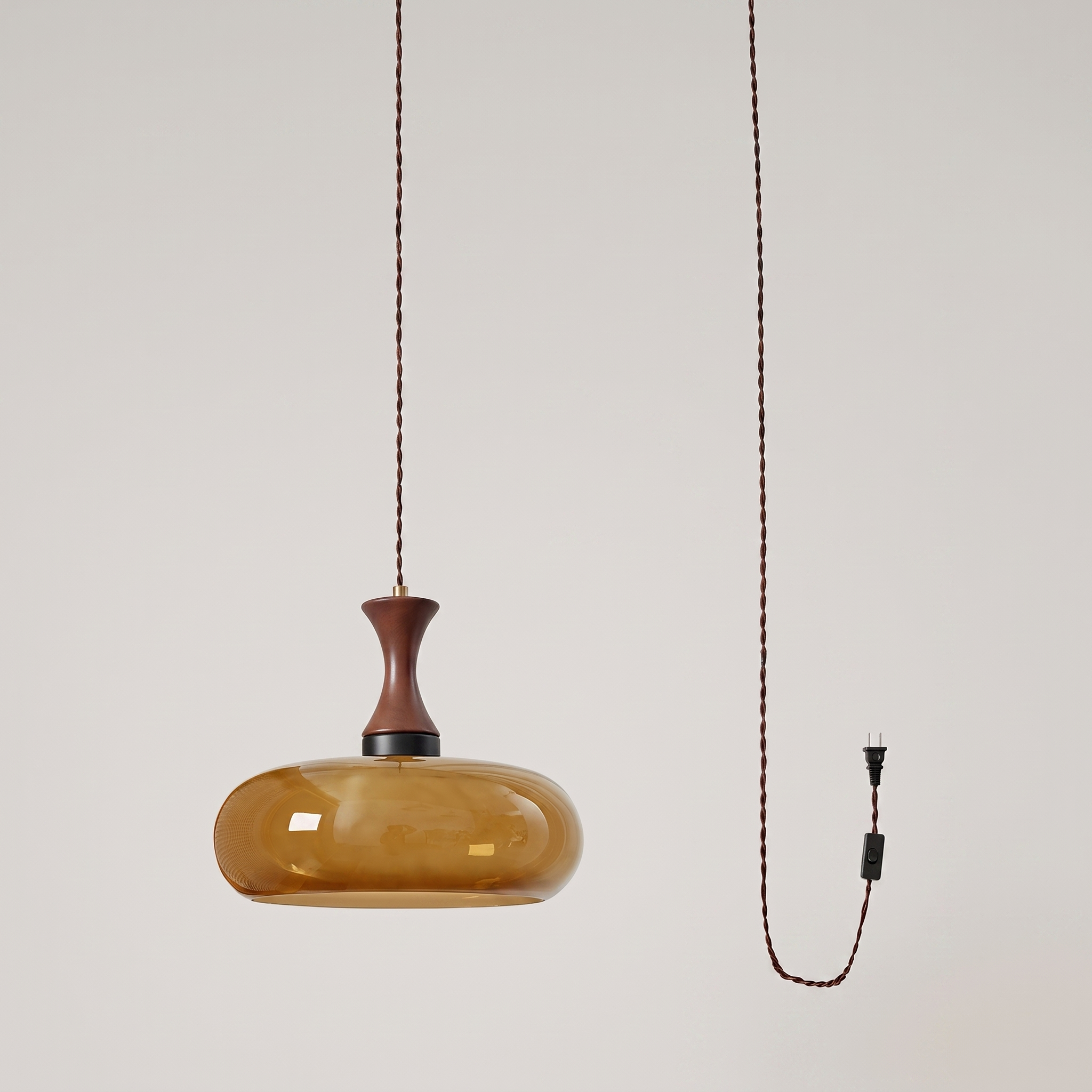 Orlena Antique Brown Glass Plug-In Pendant in antique brown glass, at a three-quarter studio angle.