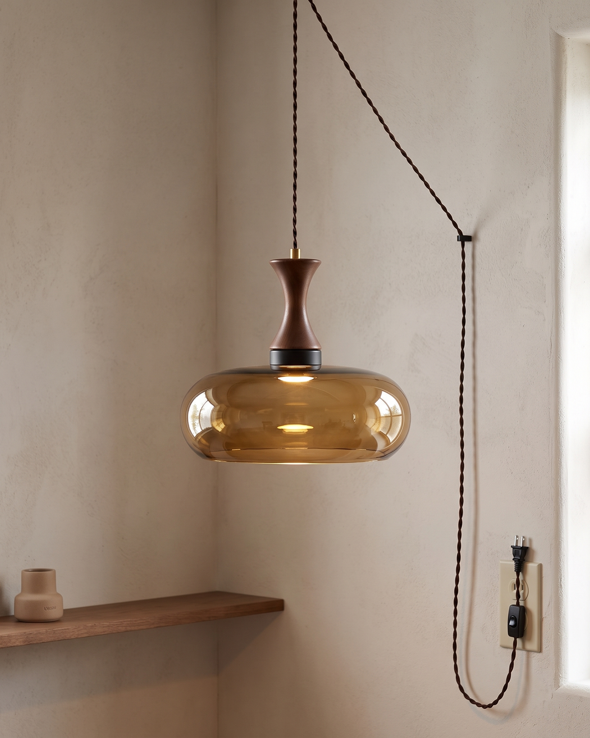 Orlena Antique Brown Glass Plug-In Pendant in a styled room