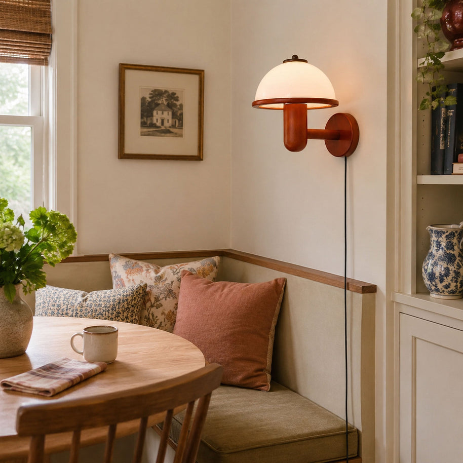Mushroom Wood Wall Lamp in Dark Oak Color, lit above a cushioned breakfast nook beside a round wooden table
