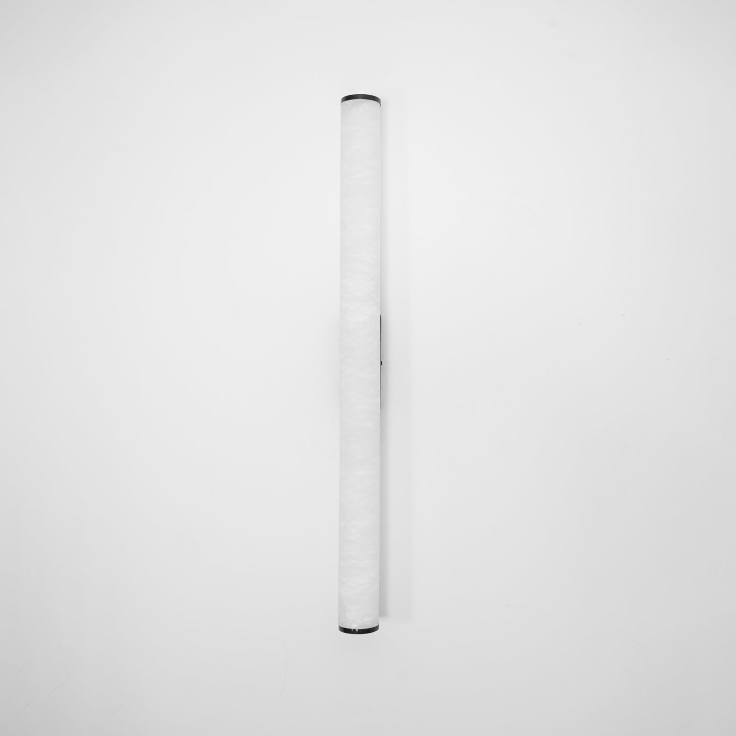 Wall lamp with a long pale veined alabaster tube and a black bracket, unlit, on a white background.