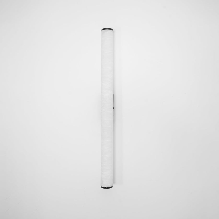 Wall lamp with a long pale veined alabaster tube and a black bracket, unlit, on a white background.