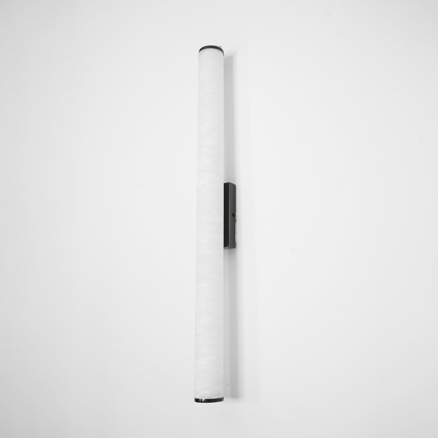 Wall lamp with a long pale veined alabaster tube and a black bracket, unlit, shown wider on a white background.
