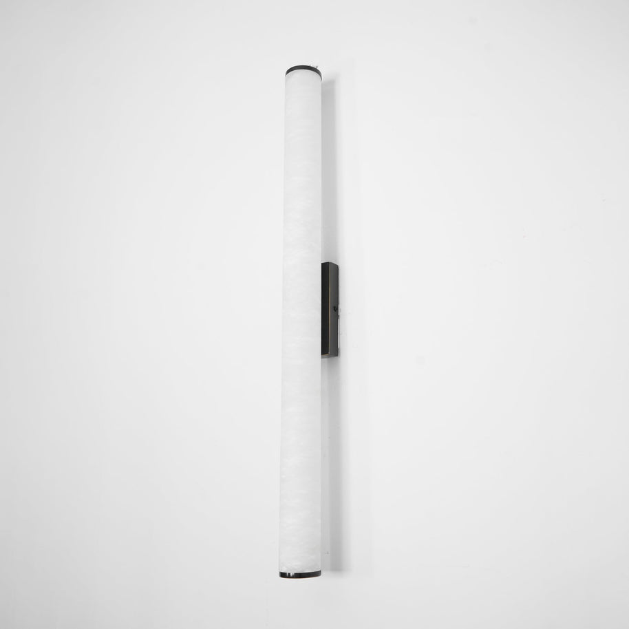 Wall lamp with a long pale veined alabaster tube and a black bracket, unlit, shown wider on a white background.