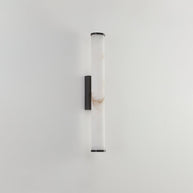 Wall lamp with a long pale veined alabaster tube and a black bracket, unlit, on a plain pale wall.