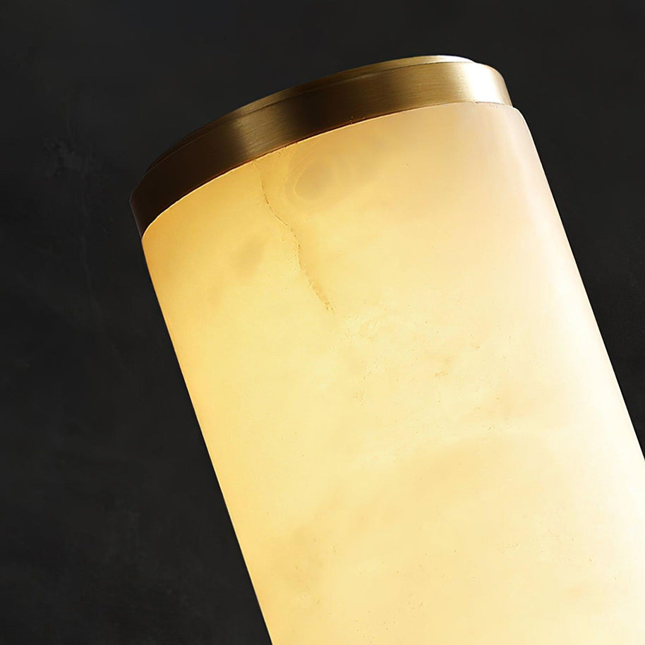 Close view of the brass-coloured end cap on the alabaster tube.