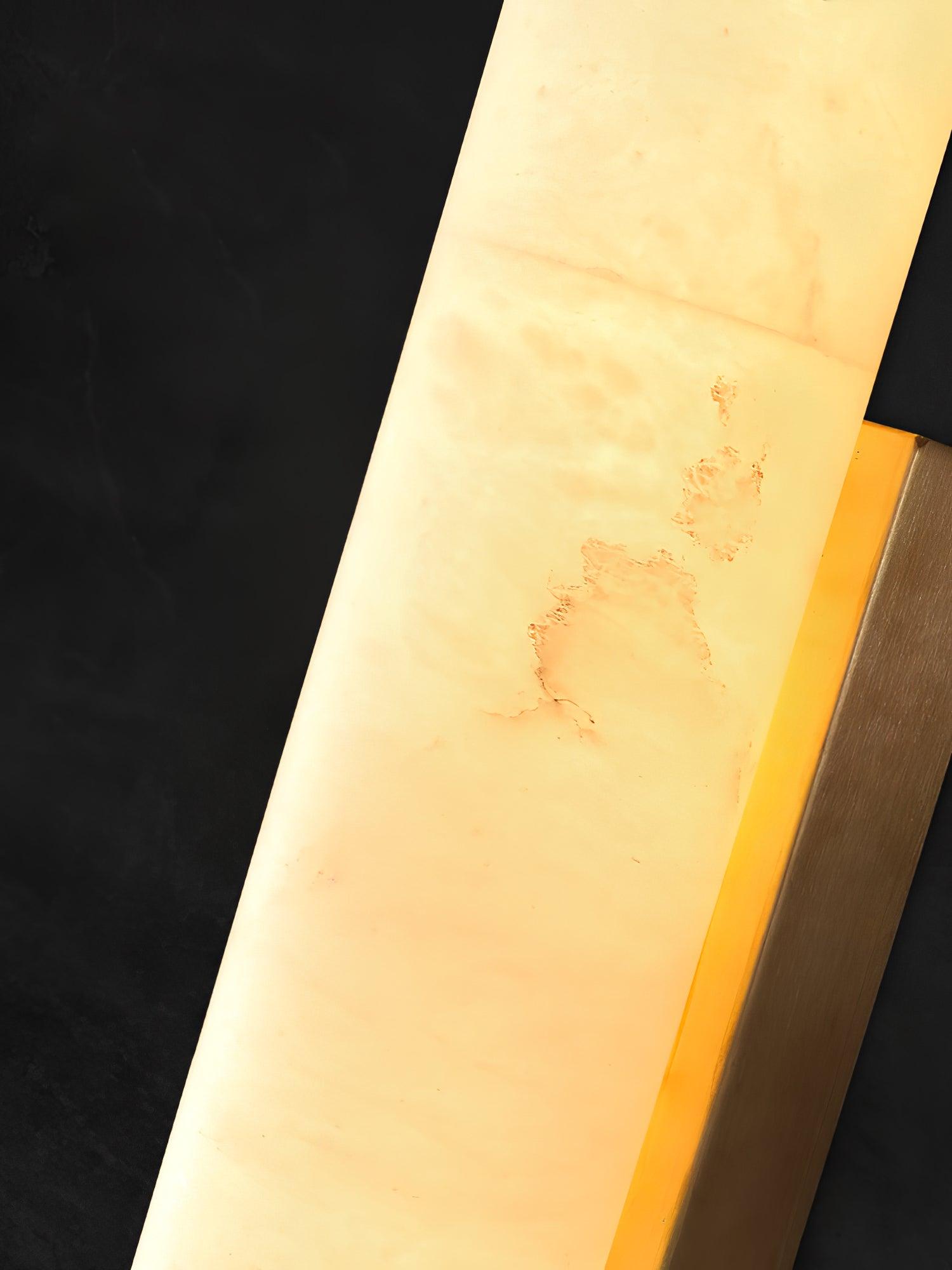 Close view of the alabaster surface showing its veining, with a brass edge.
