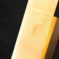 Close view of the alabaster surface showing its veining, with a brass edge.