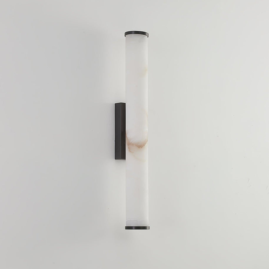 Wall lamp with a long pale veined alabaster tube and a black bracket, unlit, on a white wall.