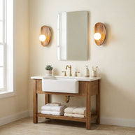 Two of the wall lamps lit either side of a bathroom mirror.