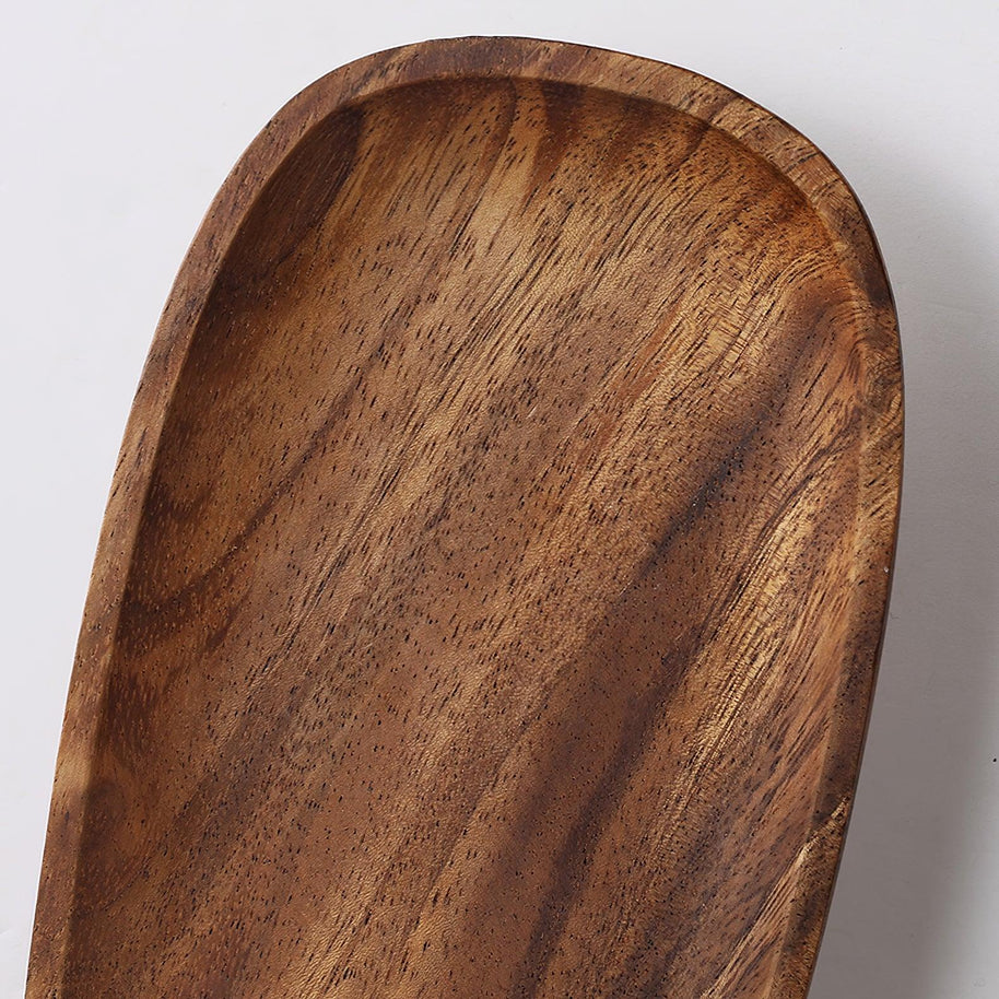 Close view of the wooden backplate showing its grain and shaped edge.