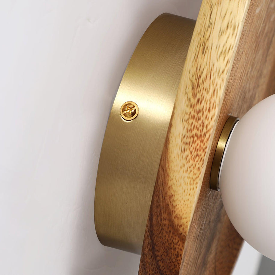 Close view of the brass fixing where the globe meets the wooden plate.