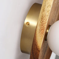 Close view of the brass fixing where the globe meets the wooden plate.