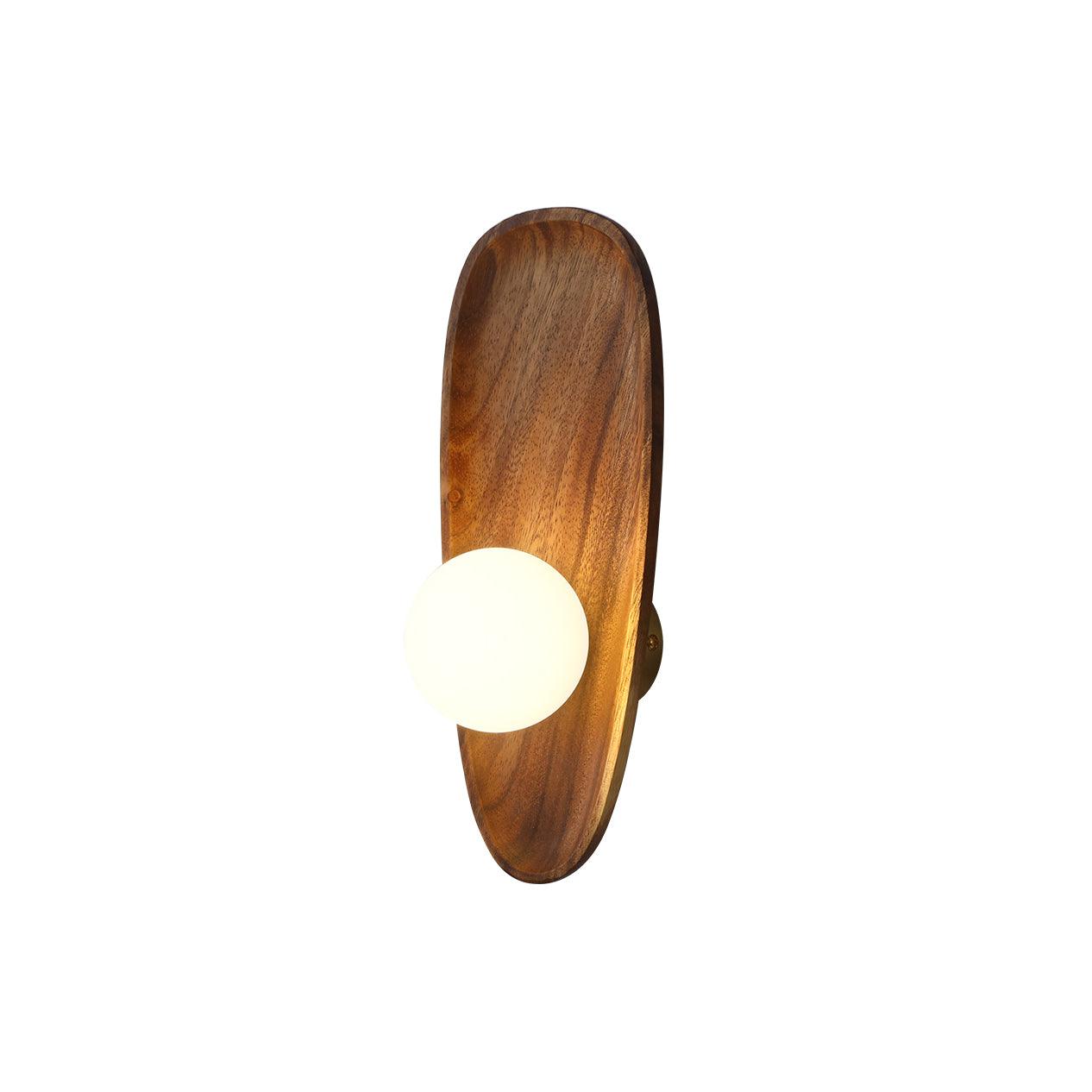 Wall lamp with a shaped walnut-coloured wooden backplate and a white glass globe lit, seen at an angle on a white background.
