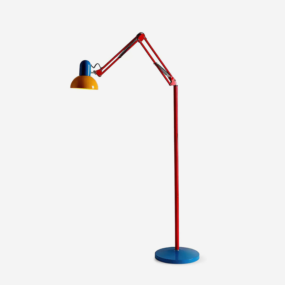 Adjustable floor lamp with a red arm, yellow shade and round blue base, arm raised, shown on a plain background.