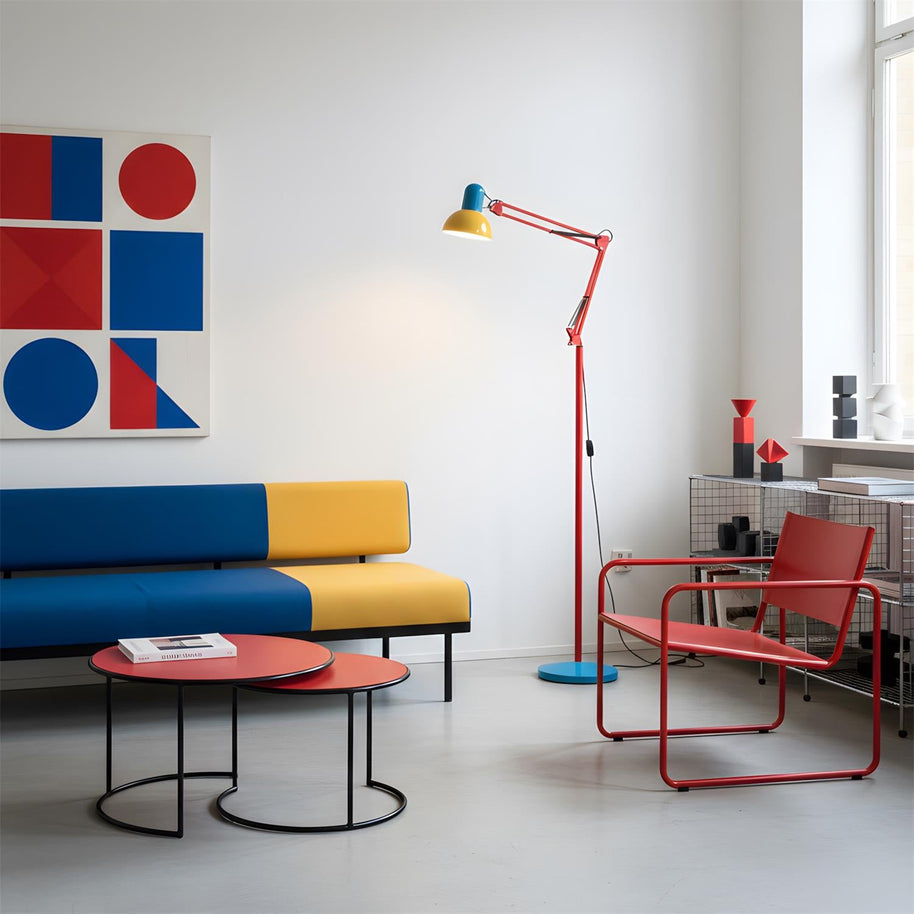 Adjustable floor lamp with a red arm, yellow shade and round blue base in a living room with a blue and yellow bench seat and a red chair.