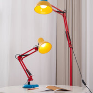 Tall floor lamp with a red adjustable arm, yellow shade and blue top, shown lit beside a matching table lamp.