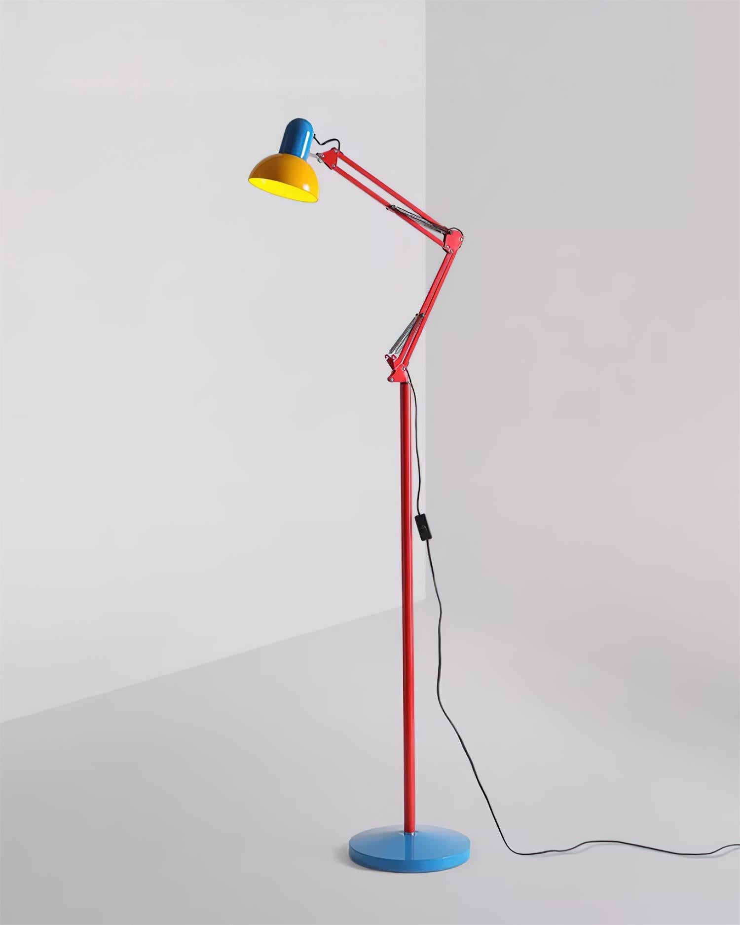 Adjustable floor lamp with a red arm, yellow shade and round blue base shown full length on a plain background.