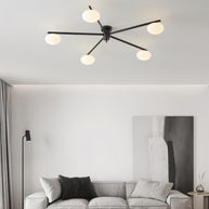 Jasper Ceiling Lamp in black and white, installed above a sofa in a pale minimalist living room