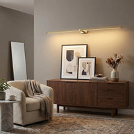 Kady Linear Rechargeable Version Wall Lamp in Gold above a sideboard in a living room
