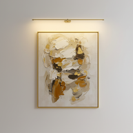 Kady Linear Rechargeable Version Wall Lamp in Gold mounted above a framed artwork