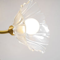 Close view of one flower-shaped glass shade with the bulb lit inside.