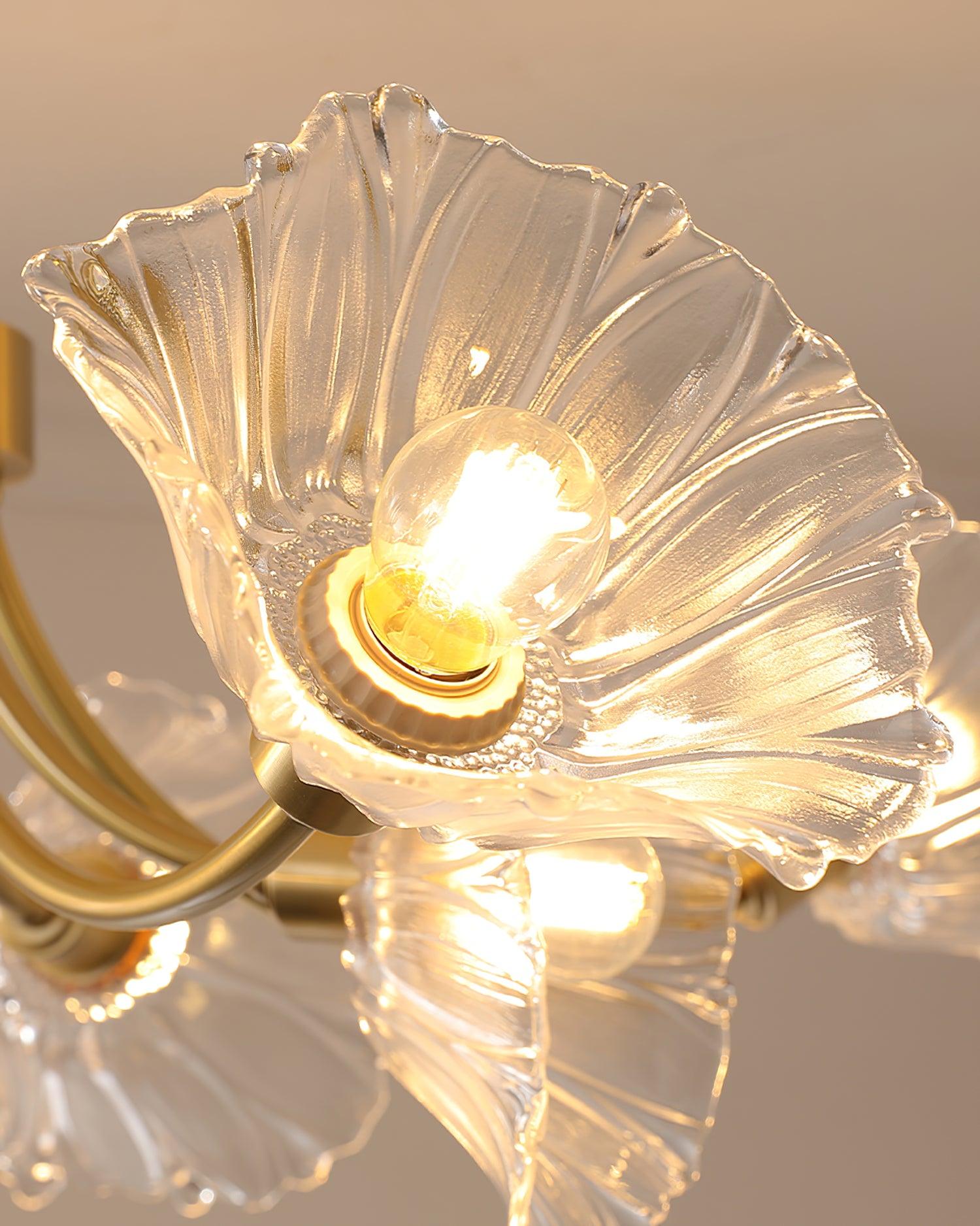 Close view of a lit bulb inside one clear flower-shaped shade.